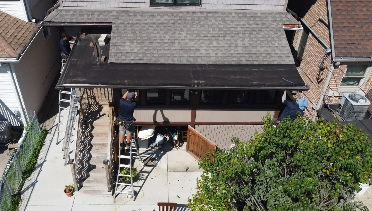 Home 32 Aerial view of crew installing seamless gutters