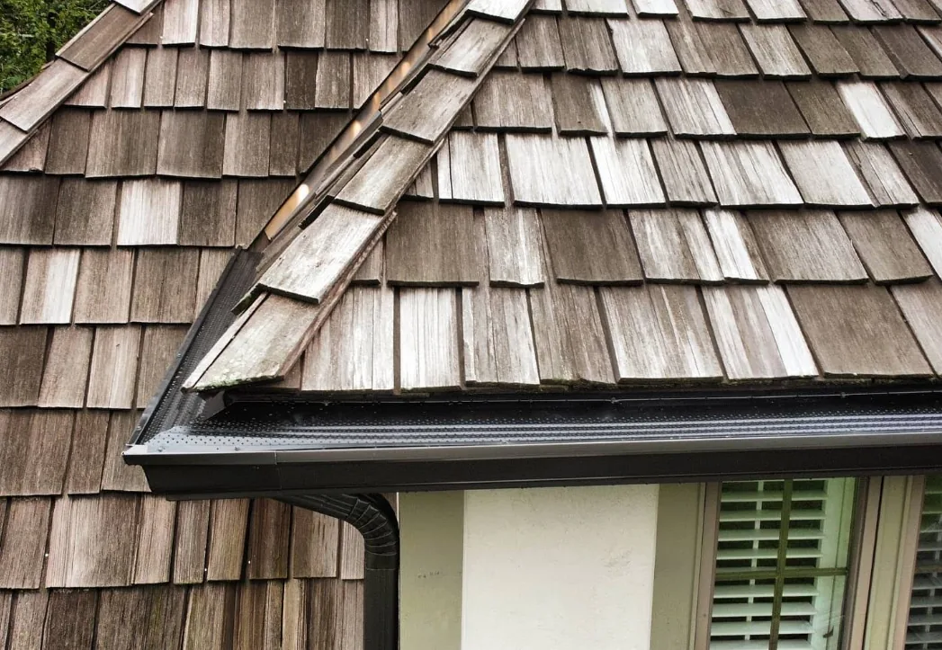 Home 33 Black seamless gutter on cedar shake roof