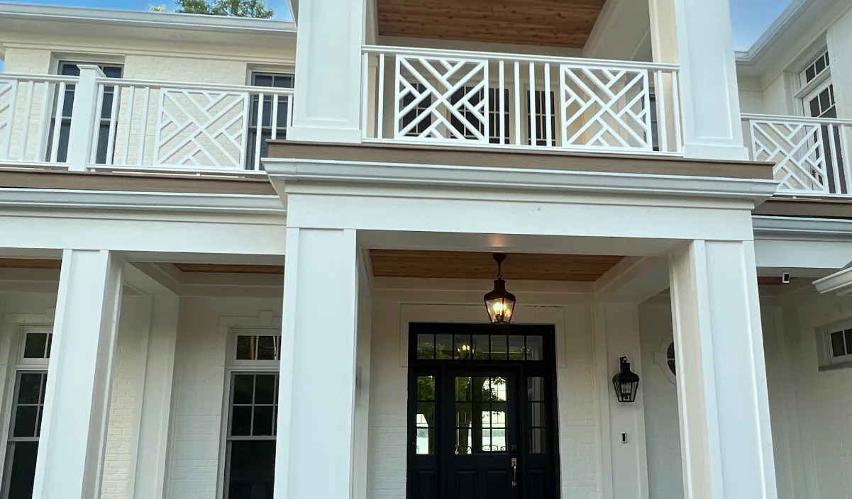 White seamless gutters on a home with a second floor balcony